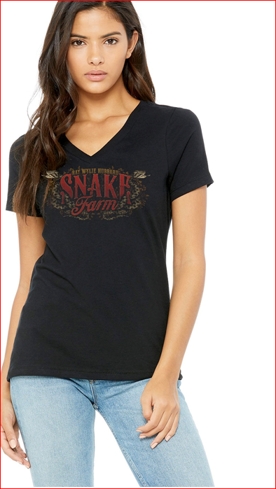A woman wearing a black short-sleeve V-neck T-shirt with 'Snake Farm' and 'Ray Wylie Hubbard' text on it, paired with blue jeans.