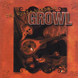 Album cover for “Growl” by Ray Wylie Hubbard. The design features a sepia-toned image of a musician sitting with a resonator guitar, surrounded by rustic objects, all framed within an ornate reddish-brown border. The album title “GROWL” appears prominently across the top.