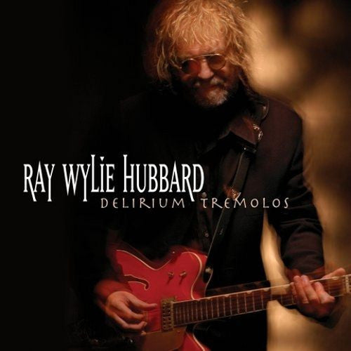 Album cover featuring a person with curly blond hair and sunglasses playing a red electric guitar against a dark background. The text on the cover reads ‘RAY WYLIE HUBBARD’ and ‘DELIRIUM TREMOLOS.