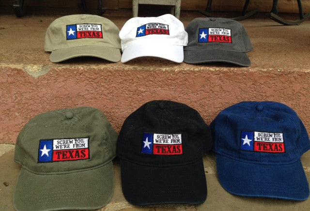 A collection of ball caps in various colors, all featuring an embroidered text 'Screw You, We're From Texas' on the front panel.